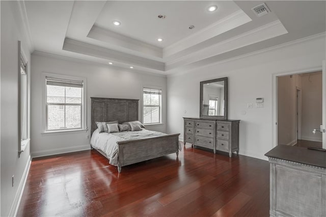 bedroom featuring crown molding, dark wood-type flooring, and a tray ceiling