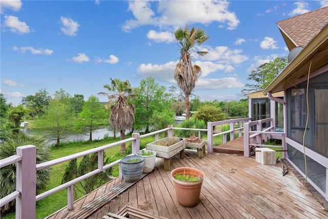 wooden deck with a water view and a sunroom