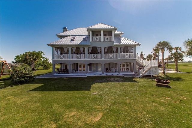 back of property featuring a patio and a yard