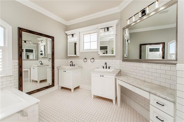 bathroom with tile floors, crown molding, double sink vanity, and tile walls