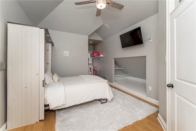 bedroom featuring vaulted ceiling, ceiling fan, and light wood-type flooring