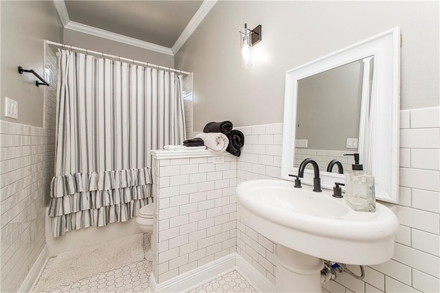 bathroom with tile flooring, toilet, and tile walls