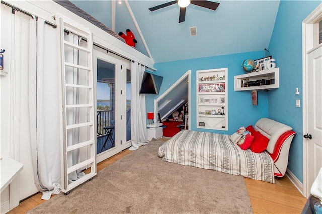 bedroom featuring ceiling fan, vaulted ceiling, hardwood / wood-style flooring, and access to exterior