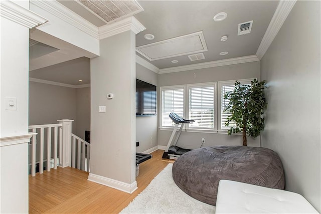 living area featuring crown molding and hardwood / wood-style flooring