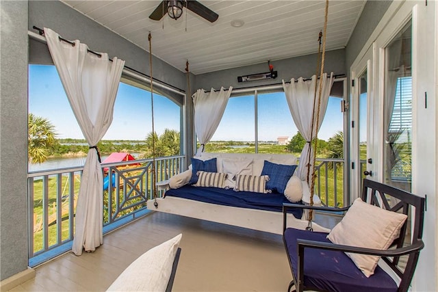 sunroom / solarium featuring ceiling fan