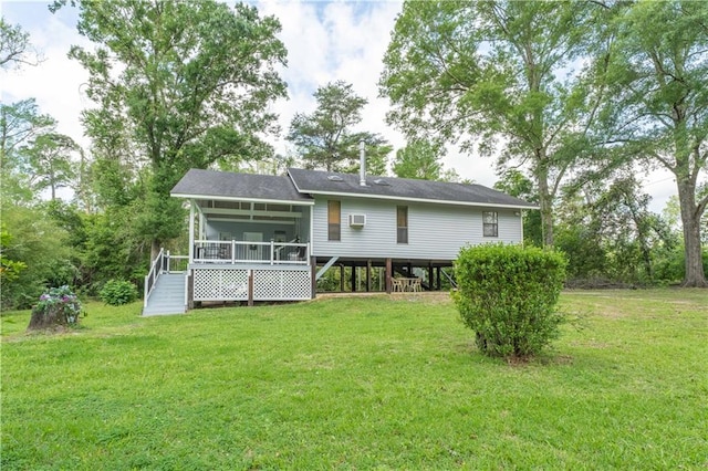 back of house with a yard and a sunroom