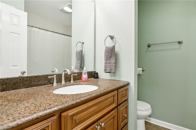 bathroom featuring tile patterned flooring, vanity, toilet, and curtained shower