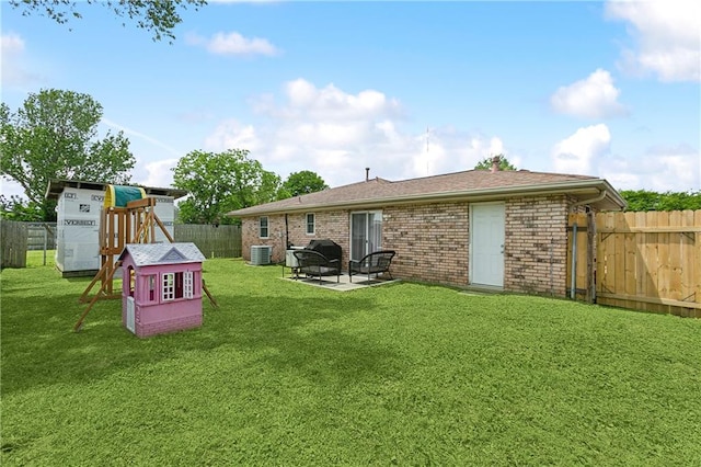 back of property with central AC unit, a yard, and a patio