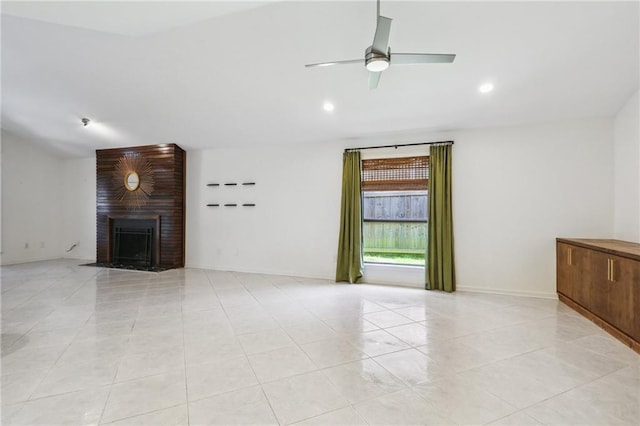 unfurnished living room featuring ceiling fan, lofted ceiling, a fireplace, and light tile patterned floors