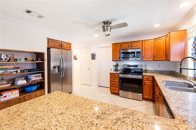 kitchen featuring sink, light tile patterned floors, light stone countertops, and appliances with stainless steel finishes