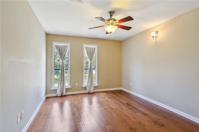 unfurnished room featuring ceiling fan and hardwood / wood-style floors