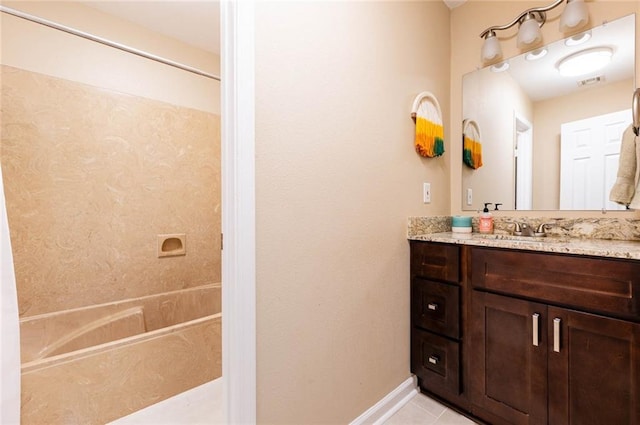 bathroom with vanity, tile patterned floors, and washtub / shower combination