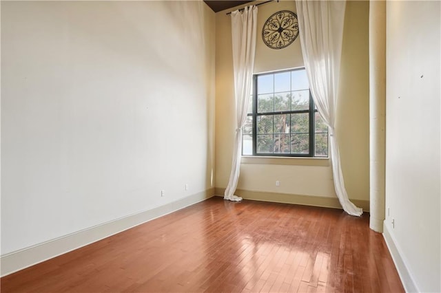 spare room with hardwood / wood-style flooring