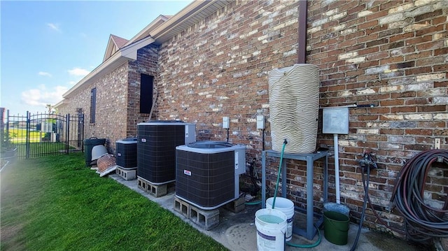 view of home's exterior featuring central AC and a yard