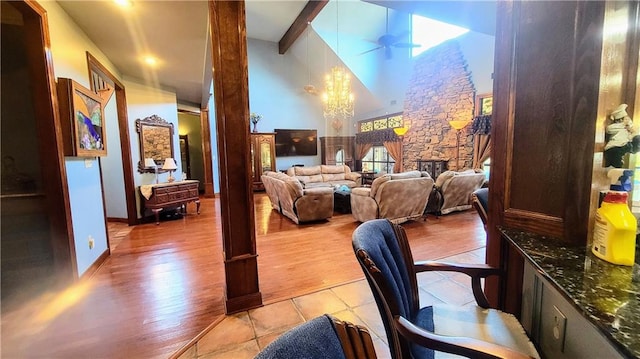 interior space featuring high vaulted ceiling, a fireplace, beam ceiling, and light hardwood / wood-style floors