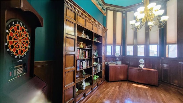 home office with a chandelier and dark hardwood / wood-style flooring