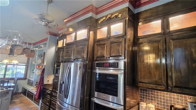 kitchen featuring dark brown cabinets, appliances with stainless steel finishes, backsplash, and light tile floors