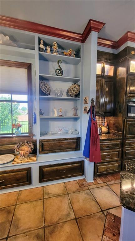 mudroom featuring crown molding and tile floors