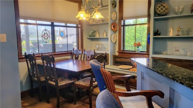 dining space featuring plenty of natural light and an inviting chandelier