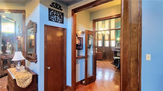 hallway with light hardwood / wood-style floors