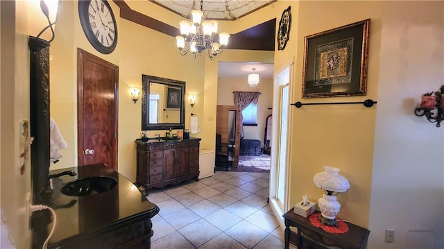 bathroom featuring tile flooring, vanity, and a chandelier