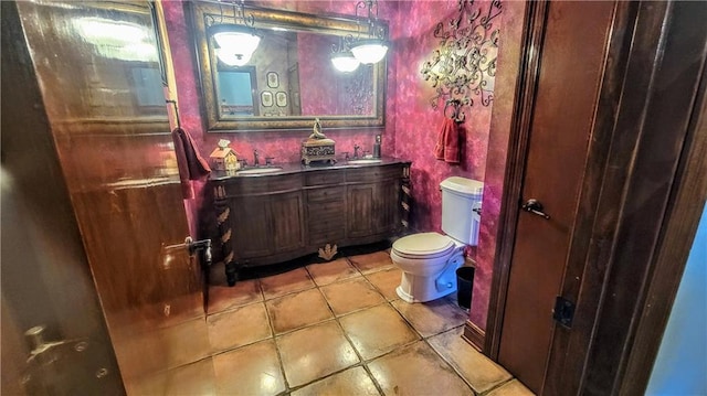 bathroom featuring vanity, toilet, and tile flooring