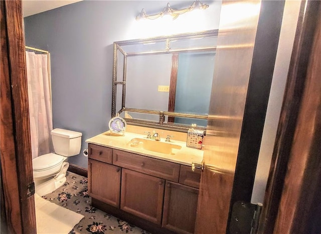 bathroom with tile floors, vanity, and toilet