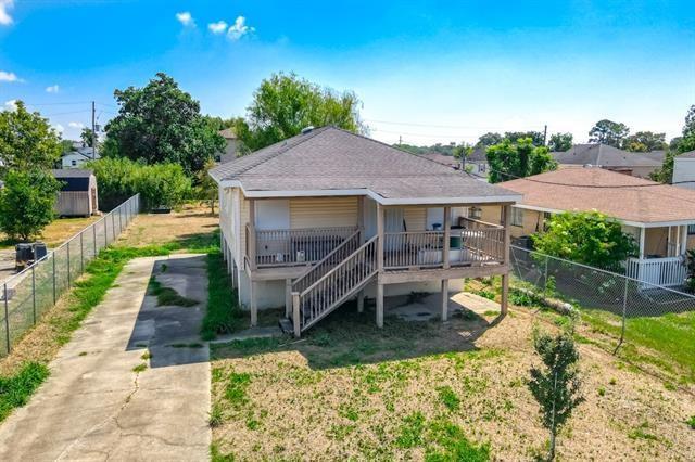 rear view of property featuring a yard