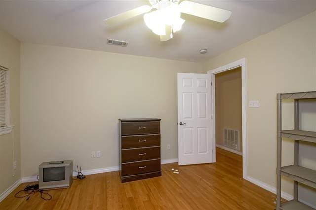 unfurnished bedroom with ceiling fan and light hardwood / wood-style floors