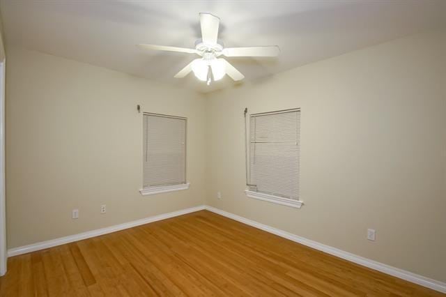 empty room featuring wood-type flooring and ceiling fan