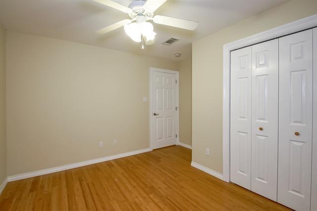 unfurnished bedroom with ceiling fan, a closet, and light hardwood / wood-style flooring