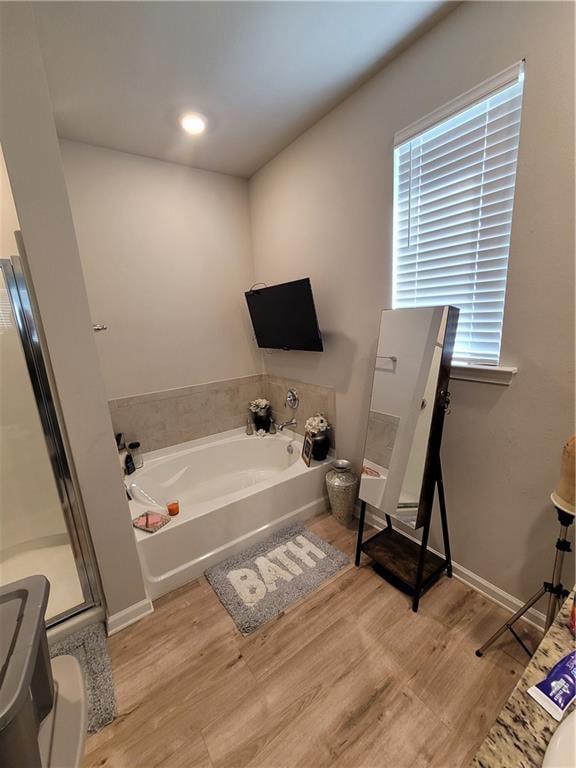 bathroom featuring hardwood / wood-style flooring and a bathtub