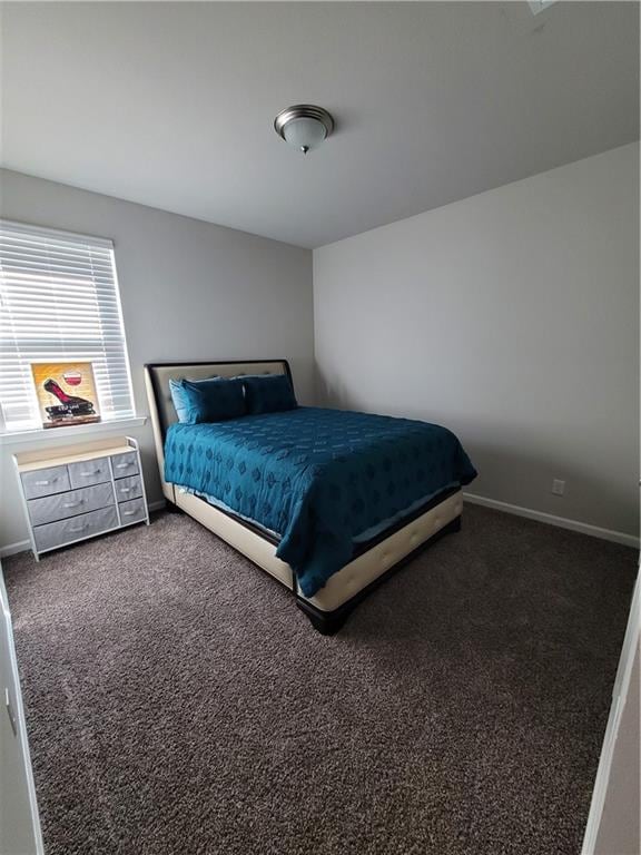 bedroom with dark colored carpet