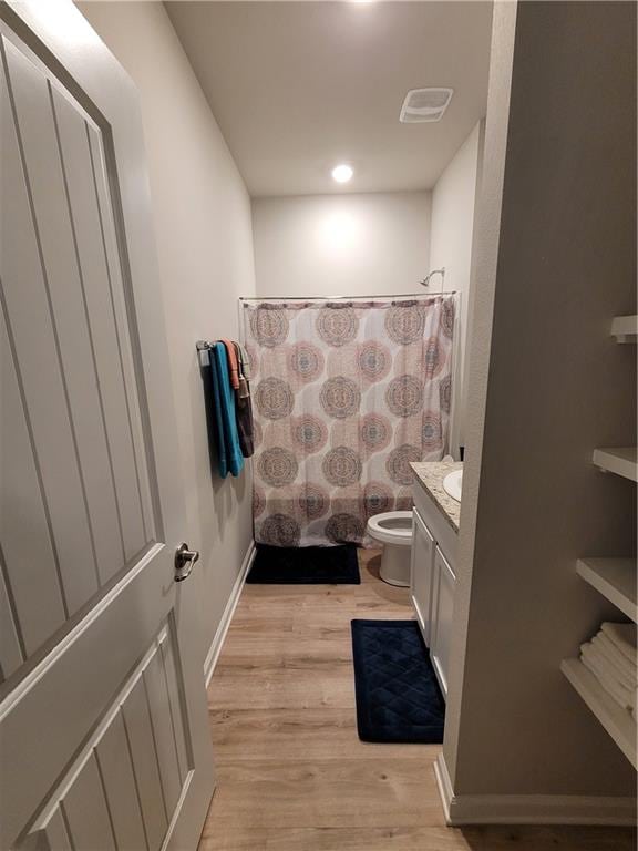 bathroom with vanity, hardwood / wood-style flooring, and toilet