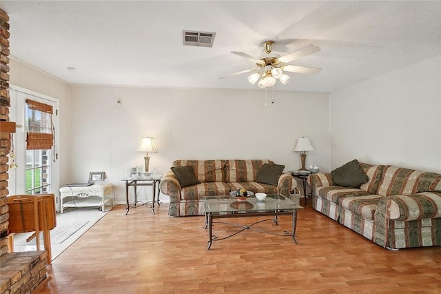 living room featuring light wood-type flooring and ceiling fan