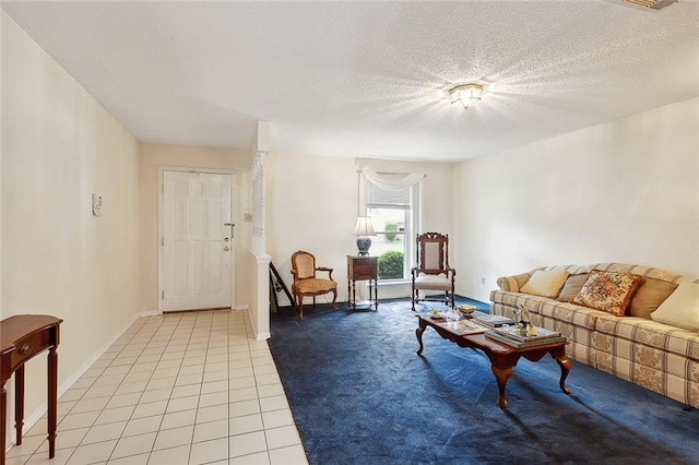 tiled living room featuring a textured ceiling