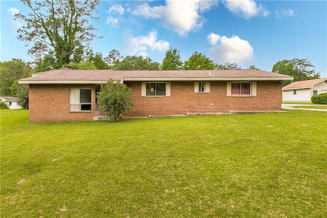 rear view of property with a lawn