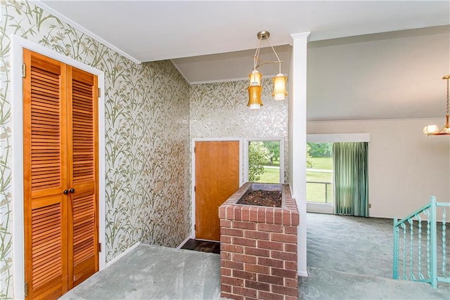 interior space featuring hanging light fixtures, ornate columns, and ornamental molding