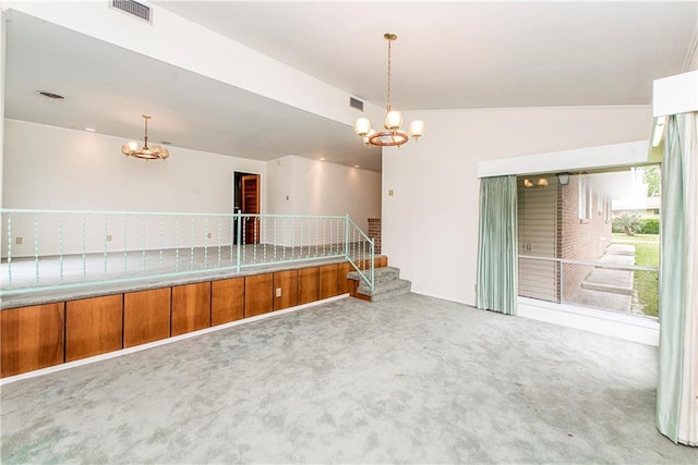 unfurnished room with vaulted ceiling, a chandelier, and carpet flooring