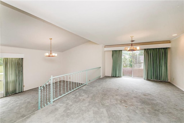 spare room with an inviting chandelier and light carpet