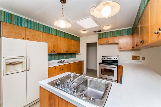 kitchen with hanging light fixtures, white refrigerator with ice dispenser, sink, and stainless steel electric range oven