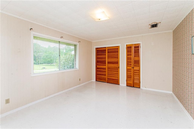 unfurnished bedroom with multiple closets