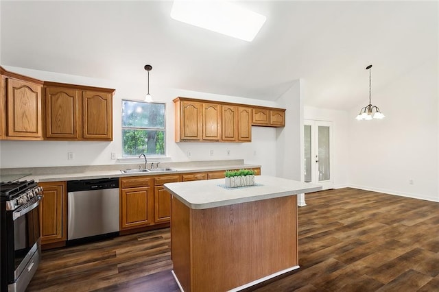 kitchen featuring a center island, sink, hanging light fixtures, dark hardwood / wood-style floors, and stainless steel appliances