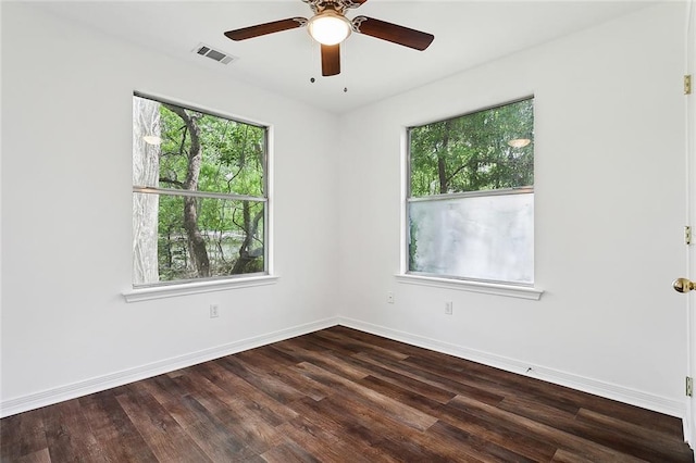 empty room featuring ceiling fan and dark wood-type flooring