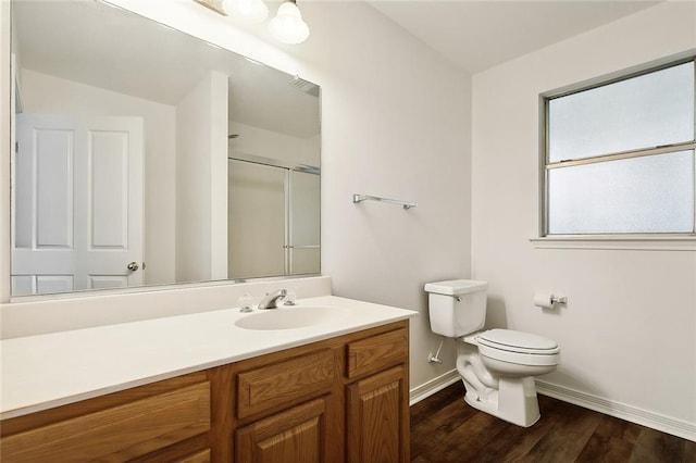 bathroom featuring toilet, vanity, hardwood / wood-style floors, and walk in shower