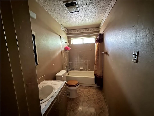 full bathroom featuring shower / bathtub combination with curtain, toilet, a textured ceiling, vanity, and tile floors