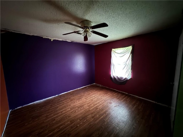 spare room with hardwood / wood-style flooring, ceiling fan, and a textured ceiling