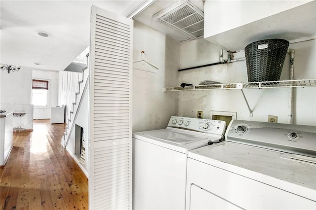 laundry room featuring hardwood / wood-style floors, independent washer and dryer, and washer hookup