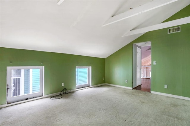 bonus room with vaulted ceiling and carpet floors