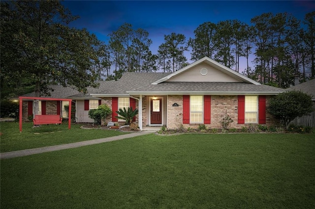 ranch-style house featuring a lawn